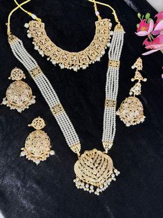 Beautiful jadau Polki Necklace layered with pearls this is intricate art done with expert craftsmen . Tika and Rings can be matched ton complete the look. light weight and Premium Quality.  Two styles shown one with long Rani Haar and another with just necklace. suitable if girl wants traditional look or brides mom for herself.  All Jewellery gets checked then dispatched. Immediate Dispatch available. No Exchange No Refunds. Comes in secured Box. Color shade displayed can vary slightly due to digital image limitations and Lighting.I hope its understood. Please expect these slight variations and imperfections when buying handmade jewelry. Jewellery Care:- Keep all Cubic Zirconia,American Diamond jewellery in a Ziplock Bag to protect it from Moisture and will last the Polish. Keep all Jewell Bridal Choker Necklace, Brides Mom, Rani Haar, Intricate Art, Wedding Necklace Set, American Diamond Jewellery, Bridal Choker, Polki Necklace, Chandbali Earrings