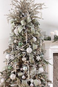 a decorated christmas tree with silver and white ornaments