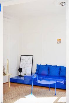 a living room with blue furniture and white walls