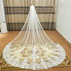 a white wedding veil on top of a rug