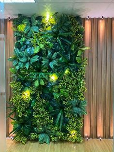 a green wall with plants and lights in the corner on display at an office building