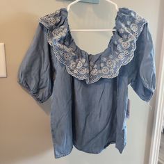 Nwt. S, M, And L Available. Elastic Neckline, Can Be Worn Off Shoulder Too. Sleeves Hit At Elbow And Have Elastic As Well. 100% Lyocell Denim Blue Cotton Blouse For Day Out, Spring Short Sleeve Denim Top With Ruffles, Spring Denim Top With Ruffles And Short Sleeves, Spring Denim Top With Ruffles Short Sleeve, Spring Denim Blue Tops, Denim Ruffled Short Sleeve Tops, Medium Wash Blouse For Spring Day Out, Spring Light Blue Chambray Denim Top, Blue Cotton Blouse With Lace Trim