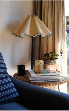 a lamp sitting on top of a table next to a blue couch