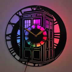 a clock that is lit up with the colors of the police call box on it