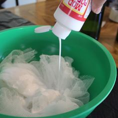 someone is pouring toilet paper into a green bowl