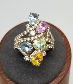 "Vintage 925 Sterling Silver Multi-Stone JDCZ Ring, Size 6.25. The various stones are multi-colored Cubic Zirconia. Ring width ranges from approximately 3.3mm - 27.6mm. Ring thickness ranges from approximately 1.1mm - 5.7mm. Ring is marked CHINA JDCZ 925 with unknown maker marks. Weighs 0.25 ozt. We do not check prongs for wear or stones for looseness. All items are sold as is-noting that we are a resale shop so everything here had a previous owner! We will include flaws in the description when European Jewelry, Vintage Fine Jewelry, Sterling Silver Flowers, Multi Stone Ring, Vintage China, Multi Stone, Silver Flowers, Selling Jewelry, Jewelry Store