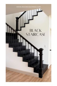 black staircase with white walls and wooden floors