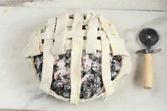 an apple pie is sitting on a counter next to a spatula