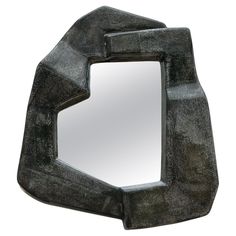 a mirror that is shaped like a geometric shape with an irregular design on the front