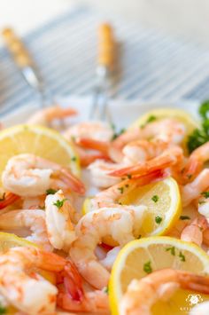 shrimp with lemons and parsley on a plate