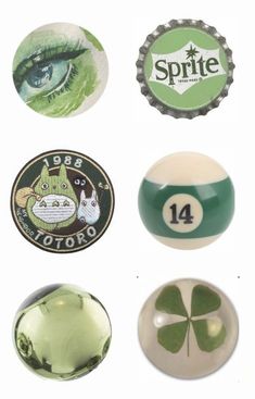 four green and white buttons, one with a cat's eye on the front