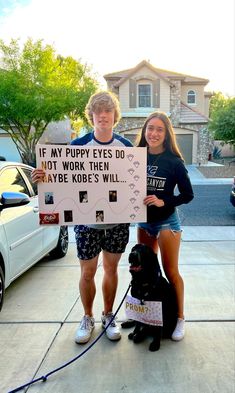 two people standing next to a dog holding a sign that says if my puppy eyes do not work then maybe rides will