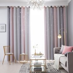 a living room filled with furniture and curtains