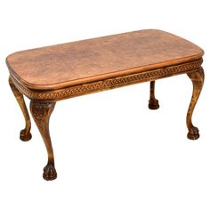 an antique wooden bench with leather top and carved details on the legs, isolated against a white background