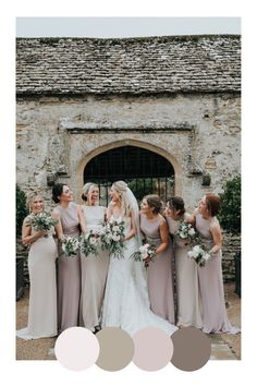 a group of women standing next to each other in front of a stone building with white flowers