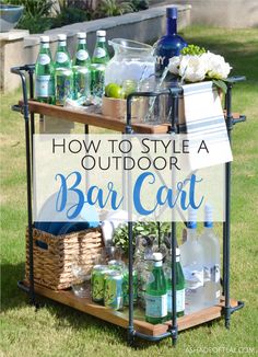 an outdoor bar cart with bottles and drinks on it