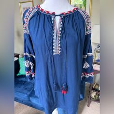 Looks Like Anthropologie! Gorgeous Tunic Blouse In Size Medium ( Could Fit A Large As It’s Loose And Generously Cut) Embroidered And Has Fun Tassels At Neckline Never Worn Blue Blouse With Geometric Embroidery For Spring, Blue Folk Style Tops For Beach, Blue Folk Style Top For Beach, Folk Style Blue Top For Beach, Bohemian Blue Tops With Embroidered Sleeves, Blue Cotton Peasant Top For Beach, Casual Blue Peasant Top With Floral Embroidery, Casual Blue Top With Embroidered Neckline, Blue Embroidered Top With Embroidered Sleeves For Summer