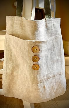 a bag with buttons on it sitting on a chair