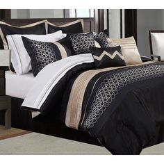 a bed with black and white comforters in a bedroom