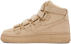 High-top faux-suede sneakers in beige. · Perforated detailing at toe · Lace-up and velcro closure · Logo embroidered at padded tongue · Padded collar · Logo embroidered at heel counter · Swoosh appliqué at sides · Logo embossed at textured rubber midsole · Treaded rubber sole Part of the Nike x Billie Eilish collaboration. Please note that this item may be shipped only within North America. Supplier colour: Mushroom/Mushroom Sporty Beige Suede High-top Sneakers, Beige Suede High-top Sneakers For Streetwear, Nike High-top Lace-up Sneakers With Studded Outsoles, Nike Beige High-top Sneakers, Beige Nike High-top Sneakers, Nike For Women, Nike Clothing, Nike Sale, Air Force 1 High