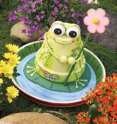 a green frog cake sitting on top of a plate