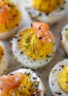 deviled eggs topped with smoked salmon and dill sprinkled with seasoning