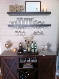 a bar with wine glasses and bottles on it