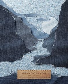 a piece of fabric with the words grand canyon printed on it and an image of a river in between two mountains