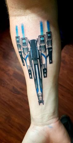 a star wars tattoo on the arm of a person's leg with blue ink