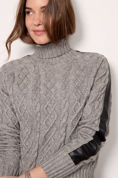 A leather sleeve detail puts a chic twist on this stylish EVEREVE sweater, featuring a turtleneck collar, wide ribbed trim, and cozy cable stitching. | EVEREVE Women's Harlow Cable Sweater Top, Size XS, Grey Fall Cable Knit Turtleneck, Trendy Cable Knit Turtleneck Outerwear, Trendy Cable Knit Turtleneck For Winter, Fitted Cable Knit Turtleneck With Funnel Neck, Turtleneck Cable Knit Outerwear For Layering, Cable Knit Turtleneck Outerwear For Layering, Fitted Cable Knit Turtleneck, Elegant Cable Knit Turtleneck For Fall, Chic Cable Knit Turtleneck Outerwear