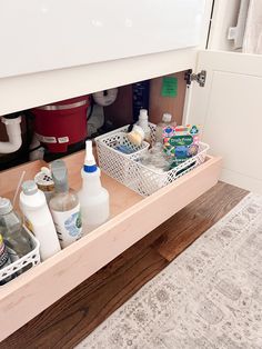 the kitchen sink is full of cleaning products and dishes in it's drawer area