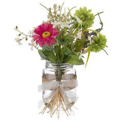 a vase filled with lots of flowers and greenery