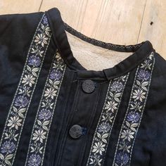 "1930s Eastern European folk jacket. Black cotton with a brushed cotton lining. Fitted and shaped to kick out at the back. The decorative ribbon is gorgeous in delicate lilacs. XXS Measures: 16\" underarm to underarm, 13\" shoulders, 16\" long in the body, 18\" sleeves Great condition. Freshly laundered. The lining looks a little grubby even though it has been washed, so it's just do to age and wear. Feel free to ask any questions. Ships internationally via insured and signed for delivery." Fitted Folk-style Cotton Outerwear, Folk Style Fitted Cotton Outerwear, Fitted Cotton Folk Outerwear, European Costumes, Floral Ribbon, Sewing Embroidery, Sewing Embroidery Designs, Eastern European, Folk Costume