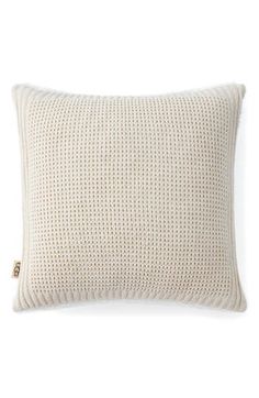 a white knitted pillow on a white background