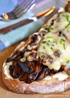 a piece of bread topped with mushrooms and cheese