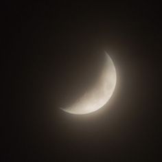 the moon is seen through the dark sky