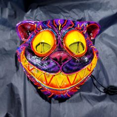 "~ The \"CREEPY CAT\" ~ Wearable Mask! Behold! My Hand sculpted and casted resin mask! painted and illuminated in El Wire Neon! YOU WONT FIND THIS ANYWHERE ELSE! The next evolution in wearable neon. -------------------------------------------------------- Stand out, Turn Heads and Get Noticed with the most INSANE El-Wire Neon designs on the market! Designed & Created Exclusively by Z'Mad Masker on Long Island, NY since 2012! Be the LIGHT of the party, create memories, friendships & more with the Stylish Fanny Pack, Creepy Cat, Cat Light, El Wire, Burning Man Festival, Cat Mask, Eye Painting, Neon Design, Create Memories