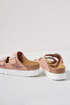 These iconic two-strap sandals get a fresh update with an EVA platform sole and a soft pink leather upper. At the heart of every Birkenstock design is the legendary footbed. The details are all in the design; each element of the footbed serves a purpose to encourage proper foot health. The result is signature style coupled with all-day comfort. | PAPILLIO BY BIRKENSTOCK Women's Arizona Platform Sandals, Size 38, Pink Pink Slide Footbed Sandals With Cushioned Footbed, Pink Cushioned Slide Footbed Sandals, Pink Leather Footbed Sandals With Removable Insole, Pink Leather Footbed Sandals For Summer, Pink Round Toe Footbed Sandals With Textured Footbed, Pink Leather Sandals With Textured Footbed, Trendy Leather Footbed Sandals With Cork-bed Midsoles, Pink Textured Footbed Sandals With Round Toe, Pink Leather Slides With Branded Insole