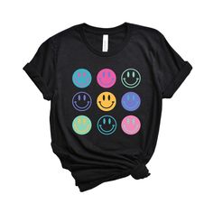 Looking for a cute versatile top to wear this summer? Make sure to grab one of our Stacked Smiley Faces tees! This soft and comfortable graphic tee is the perfect top for any outfit. It can be paired with biker shorts, jeans, or even a simple skirt/dress! This tee is true-to-size, so be sure to order your regular t-shirt size! If you are looking for a more oversized look, make sure to size up! Cute Black T-shirt With Graphic Design, Trendy Graphic Design Tops For Everyday, Fun Slogan T-shirt For Everyday, Cute Graphic Design Tops For Summer, Cute Black T-shirt For Summer, Fun Black Tops With Graphic Design, Cute Black Tops With Graphic Print, Cute Black T-shirt With Text Print, Cute Black Graphic T-shirt