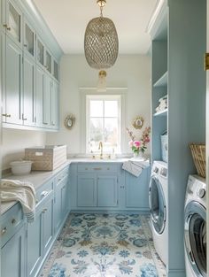 a washer and dryer in a blue laundry room with floral tile flooring