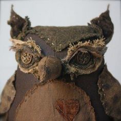 an old stuffed owl is sitting on a table