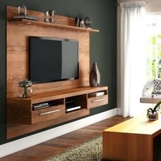 a living room with a tv on the wall