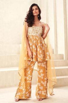 Gold floral print peplum top with floral embroidered yoke and back tie-up. Paired with a flared print pant and embellished dupatta. - Aza Fashions Anarkali Sleeveless Sets With Floral Embroidery, Sleeveless Summer Sets With Sheer Dupatta, Summer Sleeveless Sets With Sheer Dupatta, Sleeveless Anarkali Sets For Summer, Summer Sleeveless Anarkali Sets, Spring Peplum Palazzo Set, Spring Festive Peplum Palazzo Set, Festive Spring Peplum Palazzo Set, Summer Georgette Sharara With Printed Motifs