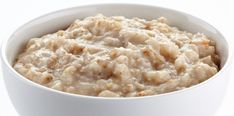 a white bowl filled with oatmeal sitting on top of a table