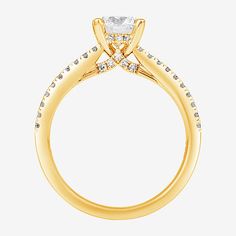 a yellow gold engagement ring with diamonds on the side