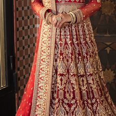 Pakistani Red Dress in Bridal Pishwas Style is the epitome of royalty and grace, and it wins everyone's hearts at the very first glance. This beautiful Pakistani Bridal Dress is emblazoned with lavish goldwork and embroidery, creating a breathtaking masterpiece for the gorgeous bride. Pishwas: Pakistani Bridal Pishwas in the alluring red shade is hand-crafted with zardosi and embroidery details. Lavish goldwork and designs make this stunning Pakistani Red Dress your foremost priority for the wed Pakistani Red Dress, Pakistani Bride Dress Red, Pishwas Pakistani, Bridal Pishwas, Red Pakistani Bridal Dress, Red Bridal Gown Pakistani, Deep Red Pakistani Bridal Dress, Red And Gold Pakistani Bridal Dress, Pakistani Bridal Dress