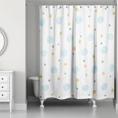 a bathroom with a shower curtain, mirror and white dresser in front of the bathtub