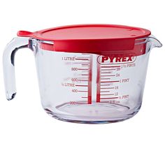 a measuring cup with a red lid