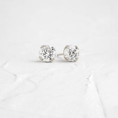 A pair of matching round brilliant cut diamonds in your choice of natural or lab-grown diamond. Please note: these earrings are listed with the total carat weight for both studs together. Each diamond is SI+ clarity, G+ color. Solid 14k gold posts and butterfly backings. Also available in platinum. Sold as a pair. We handcraft each piece with responsibly sourced metals and ethically sourced stones. Everyday White Gold Diamond Earrings With Single Diamond, Minimalist Solitaire Cubic Zirconia Diamond Earrings, Minimalist Solitaire Diamond Earrings, Everyday White Diamond Earrings With Prong Setting, Minimalist Cubic Zirconia Solitaire Diamond Earrings, Minimalist White Diamond Earrings With Brilliant Cut, Minimalist Solitaire Diamond Earrings In White Gold, Classic Diamond White Diamond Earrings For Everyday, Diamond Cut Diamond Earrings