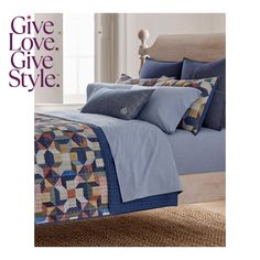 a bed covered in blue sheets and pillows with the words give love style on it